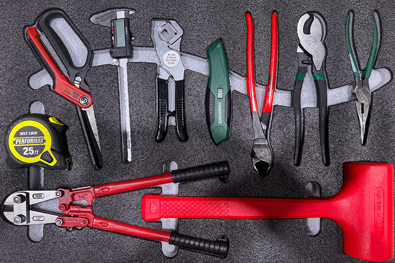 Custom foam insert for tools including pliers, hammer, and tape measure