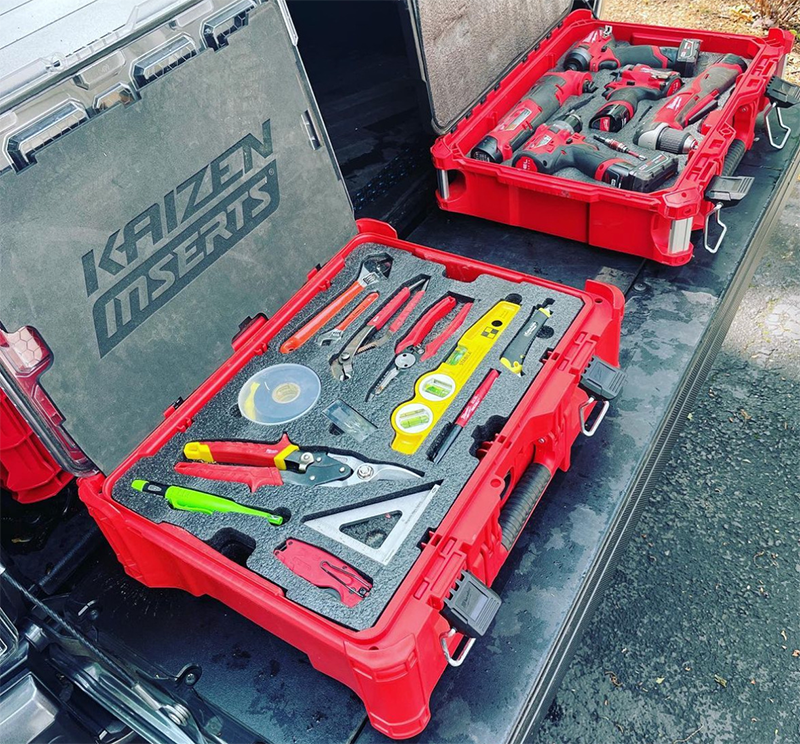 Custom foam inserts in red Milwaukee tool cases on truck tailgate