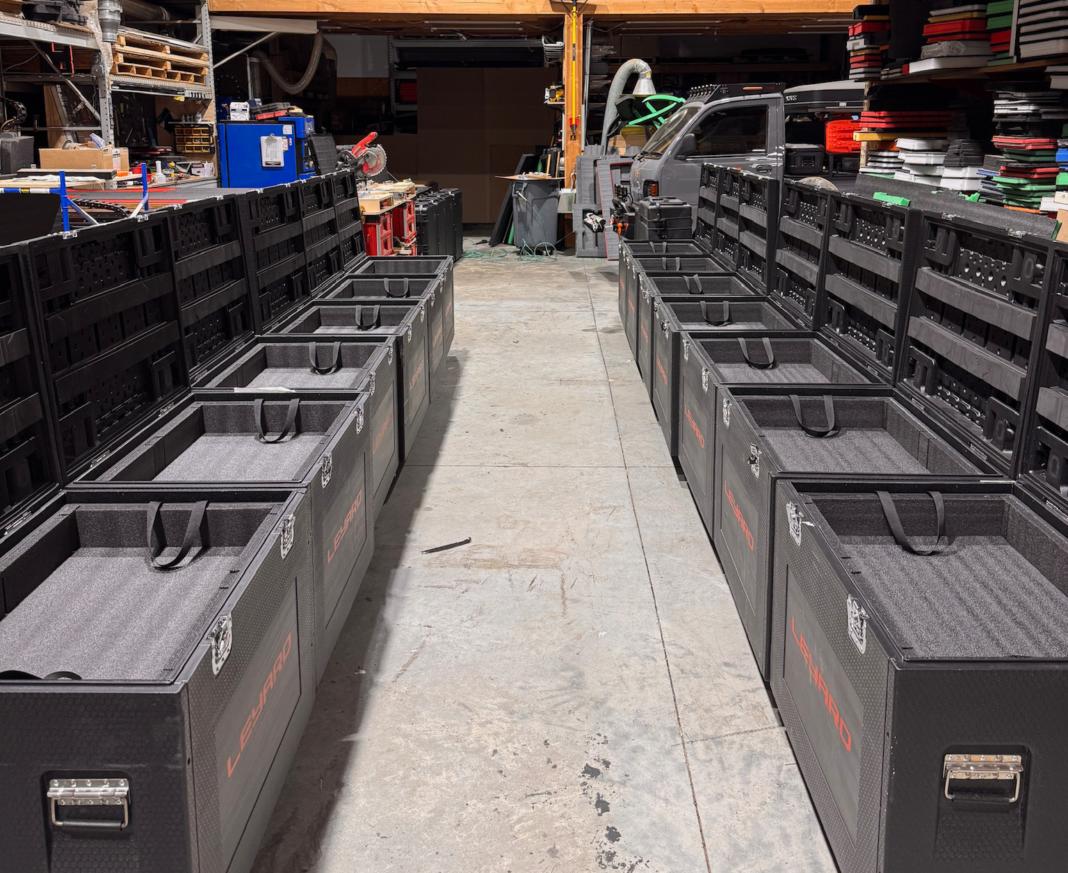 Rows of black foam-lined toolboxes in workshop